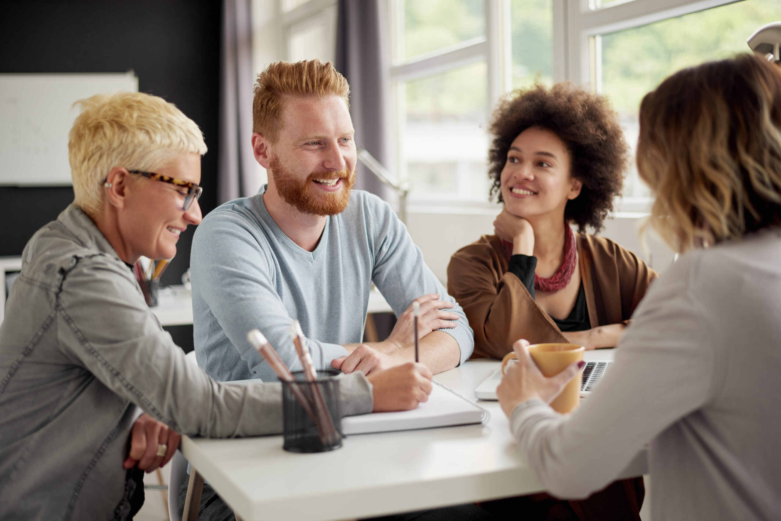 Colleagues chatting at a table