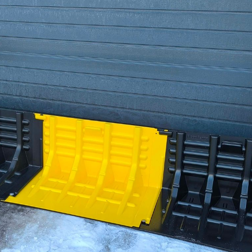 Yellow and back flood fence across a garage door entrance