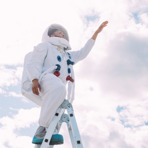 Astronaut using a ladder